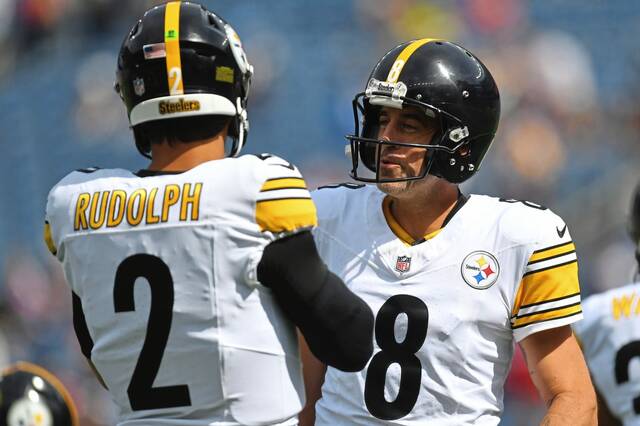 Pittsburgh Steelers quarterback Mason Rudolph (2) and Steelers quarterback Aaron Rodgers (8) speak while warming up before an NFL football game against the New England Patriots, Sunday, Sept. 21, 2025, in Foxborough, Mass.