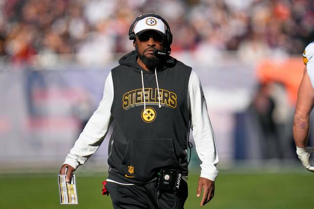 Pittsburgh Steelers head coach Mike Tomlin walks on the sideline during the first half of an NFL football game against the Chicago Bears, Sunday, Nov. 23, 2025, in Chicago.