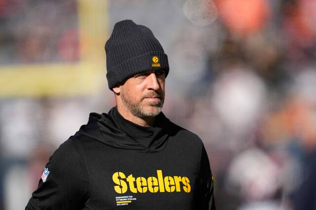 Pittsburgh Steelers quarterback Aaron Rodgers watches warm ups before an NFL football game against the Chicago Bears, Sunday, Nov. 23, 2025, in Chicago.