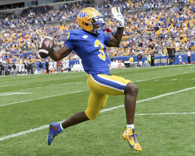 Pitt’s Rasheem Biles returns an interception for a touchdown during the first quarter against Louisville on Sept. 27 at Acrisure Stadium.