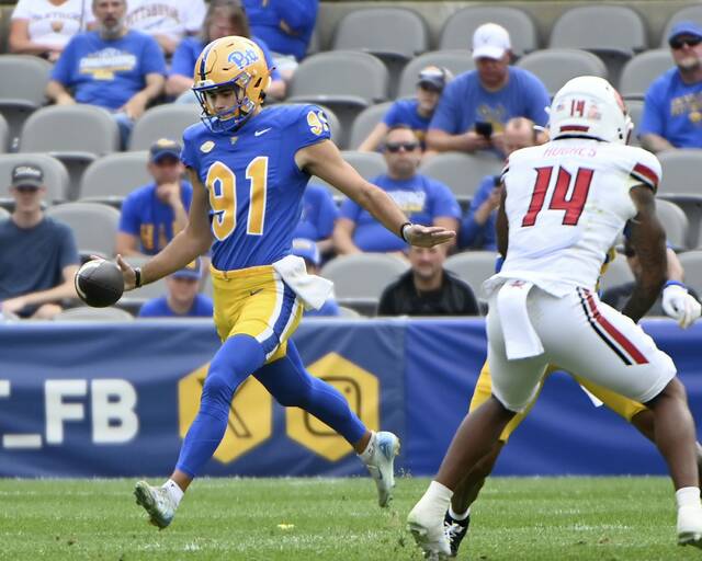 Pitt punter Caleb Junko gets off a kick against Louisville on Sept. 27 at Acrisure Stadium.