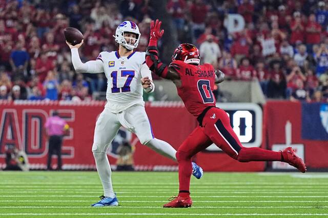 Buffalo Bills quarterback Josh Allen (17) throws a pass under pressure from Houston Texans linebacker Azeez Al-Shaair (0) in the first half of an NFL football game Thursday, Nov. 20, 2025, in Houston.