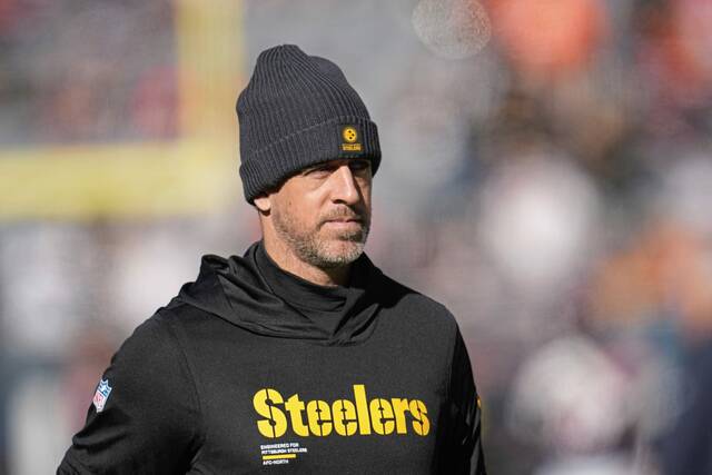 Pittsburgh Steelers quarterback Aaron Rodgers watches warm ups before an NFL football game against the Chicago Bears, Sunday, Nov. 23, 2025, in Chicago
