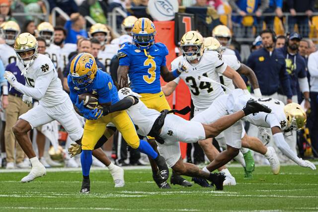 Pitt running back Desmond Reid (0) fights for extra yards against Notre Dame on Saturday, Nov. 15, 2025, at Acrisure Stadium.