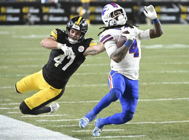 Bills running back James Cook III gets past linebacker Payton Wilson down the sideline in the fourth quarter Sunday at Acrisure Stadium.
