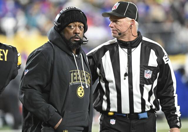 Steelers head coach Mike Tomlin with back judge Scott Helverson on the sideline against the Bills on Sunday, Nov. 30, 2025 at Acrisure Stadium.