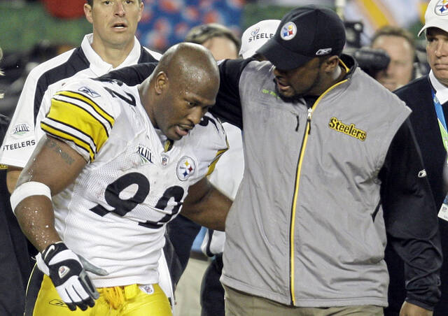 Steelers linebacker James Harrison is congratulated by head coach Mike Tomlin following Harrison’s 100-yard interception return for a touchdown in Super Bowl XLIII on Feb. 1, 2009.
