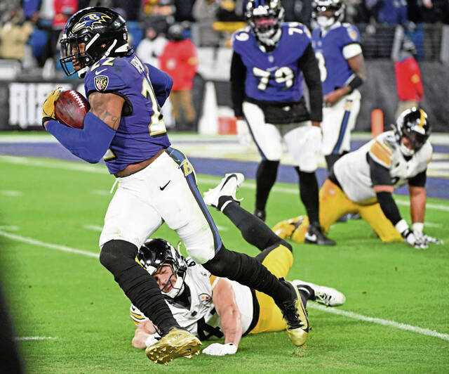 Ravens running back Derrick Henry gets past Steelers linebacker Payton Wilson in a playoff game Jan. 11 at M&T Bank Stadium. (Chaz Palla | TribLive)