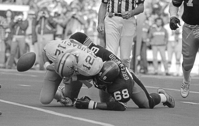In this Oct. 28, 1979 file photo, the ball pops loose as Dallas quarterback Roger Staubach is tackled by Pittsburgh Steelers’ L.C. Greenwood during a football game in Pittsburgh. Greenwood, who won four Super Bowls as a member of the “Steel Curtain” defense, died Sunday, Sept. 29, 2013 at Presbyterian Hospital in Pittsburgh. He was 67. (AP)