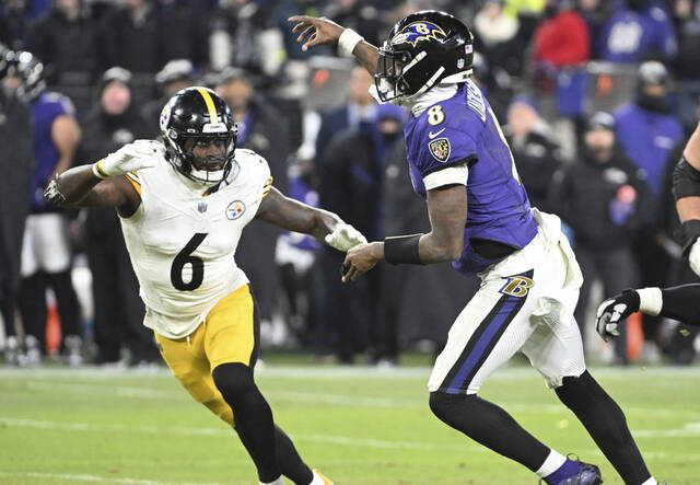 Shown while throwing a touchdown pass during a playoff game against the Pittsburgh Steelers this past January, Baltimore Ravens quarterback Lamar Jackson had a 69.7 passer rating and 56% completion percentage during four starts in November. (Chaz Palla | TribLive)
