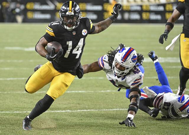 Steelers running back Kenneth Gainwell gets outside on the Bills’ Dorian Williams and Tre’Davious White in the second quarter Sunday, Nov. 30, 2025 at Acrisure Stadium. (Chaz Palla | TribLive)