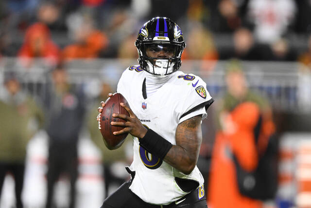 Ravens quarterback Lamar Jackson rolls out of the pocket against the Browns in Cleveland on Nov. 16. (AP)