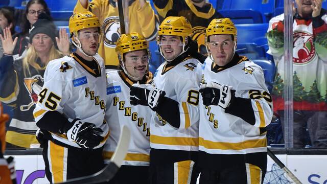 Wilkes-Barre/Scranton Penguins (left to right) defenseman Harrison Brunicke and forwards Avery Hayes, Aidan McDonough and Sam Poulin celebrate during a 6-2 win against the Lehigh Valley Phantoms at the Mohegan Arena in Wilkes-Barre on Friday (KDP Studio).