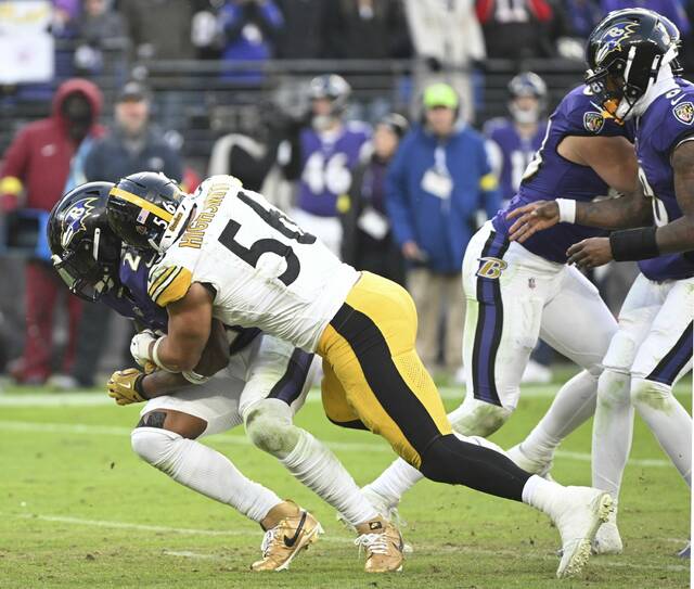 Steelers linebacker Alex Highsmith drops Ravens running back Derick Henry for a loss in the fourth quarter Sunday. (Chaz Palla | TribLive)