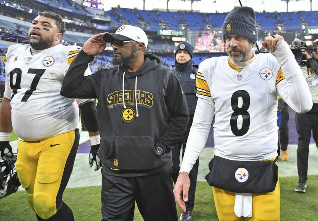 The Steelers’ Cam Heyward, Mike Tomlin and Aaron Rodgers acknowledge the crowd as they leave the field after beating the Ravens to take the lead in the AFC North on Sunday, Dec. 7, 2025 at M&T Bank Stadium. (Chaz Palla | TribLive)