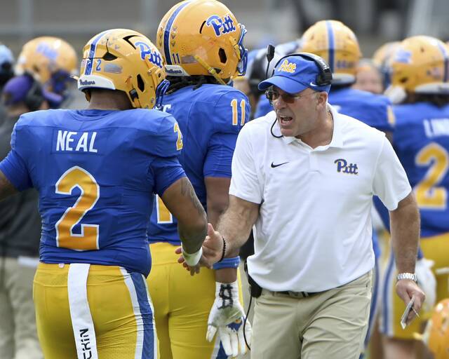 Pitt head coach Pat Narduzzi celebrates with defensive lineman Isaiah Neal during the Panthers’ game against Louisville on Sept. 27, 2025, at Acrisure Stadium. (Christopher Horner | TribLive)