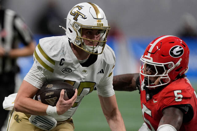 Georgia Tech quarterback Haynes King (10) runs against Georgia linebacker Raylen Wilson (5) during the first half of an NCAA college football game, Friday, Nov. 28, 2025, in Atlanta. (AP)