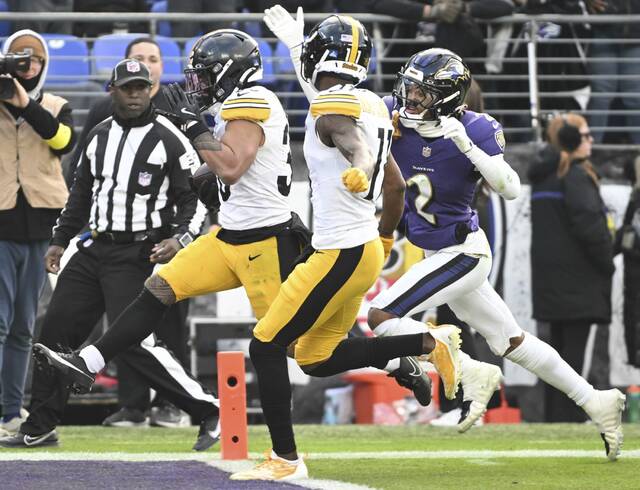 Steelers running back Jaylen Warren beats the Ravens’ Nate Wiggins to the end zone for a third-quarter touchdown Sunday. (Chaz Palla | TribLive)