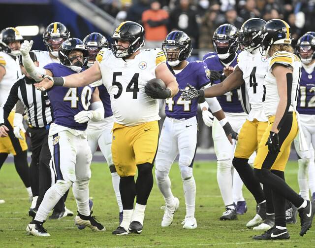 Steelers center Zach Frazier ends up with the ball on a tipped Aaron Rodgers pass against the Ravens fourth quarter Sunday at M&T Bank Stadium in Baltimore. (Chaz Palla | TribLive)