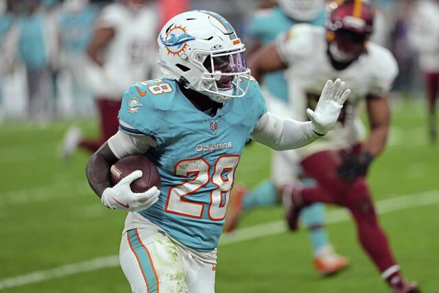Dolphins running back De’Von Achane carries the ball Nov. 16 against the Washington Commanders in a game in Madrid, Spain. (AP Content Services for the NFL)