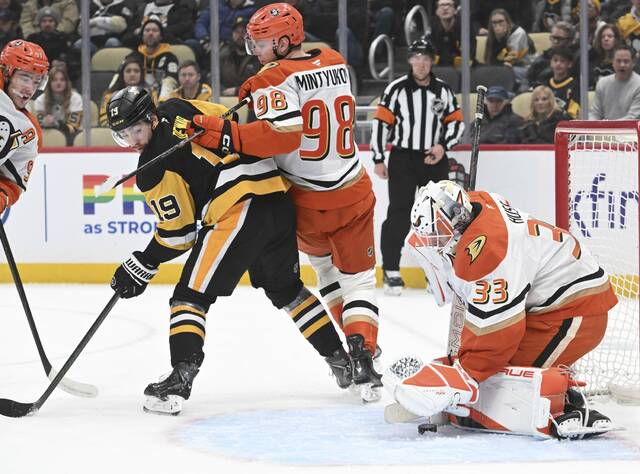 The Penguins’ Connor Dewar looks back as Ducks goaltender Ville Husso makes a save in the first period Tuesday at PPG Paints Arena. (Chaz Palla | TribLive)