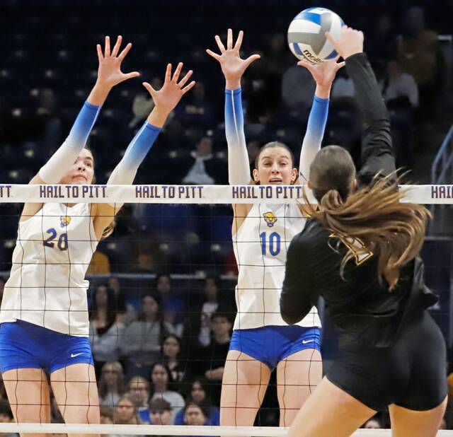 Pitt's Abbey Emch (left) and Marina Pezelj put up a block ahead of an attempted kill by UMBC's Claudia Llamas during the first round of the NCAA women's volleyball tournament Friday at Petersen Events Center. (Josh Rizzo | For TribLive)