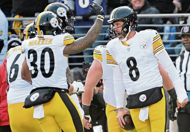 Steelers quarterback Aaron Rodgers celebrates with the offense after scoring a touchdown against the Ravens in the first quarter Sunday, Dec. 07, 2025 at M&T Bank Stadium. (Chaz Palla | TribLive)