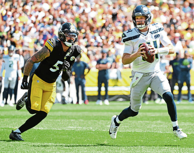 Seahawks QB Sam Darnold gets way from the Steelers’ Nick Herbig on Sept. 14, 2025 at Acrisure Stadium. (Chaz Palla | TribLive)