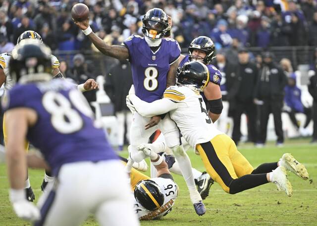 The Steelers’ Alex Highsmith and Nick Herbig pressure Ravens quarterback Lamar Jackson in the fourth quarter Sunday, Dec. 7, 2025 at M&T Bank Stadium. (Chaz Palla | TribLive)