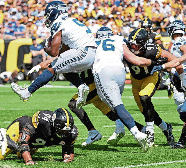 Pittsburgh Steelers defensive tackle Yahya Black gets leaped over by Seahawks running back Kenneth Walker III during a game early this season. Black did not practice Friday because of a shoulder injury. (Chaz Palla | TribLive)
