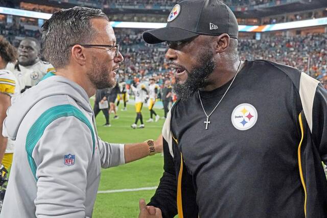 Miami coach Mike McDaniel greets Steelers coach Mike Tomlin in 2022 after the Dolphins won 16-10. (AP)