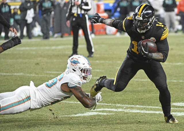 Pittsburgh Steelers running back Kenneth Gainwell steps out of the tackle attempt by Miami Dolphins cornerback Rasul Douglas during the second quarter of Monday’s game at Acrisure Stadium. Gainwell has played a significantly bigger role in the Steelers offense this season than most expected when he signed as a free agent in March. (Chaz Palla | TribLive)