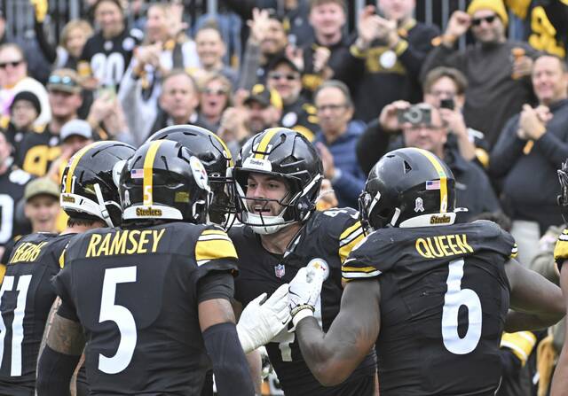 The Steelers celebrate with Payton Wilson after Wilson’s interception against the Colts last month. (Chaz Palla | TribLive)